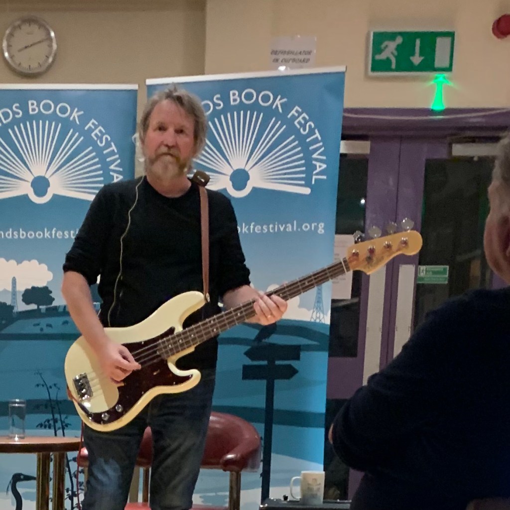 Derek Forbes with guitar